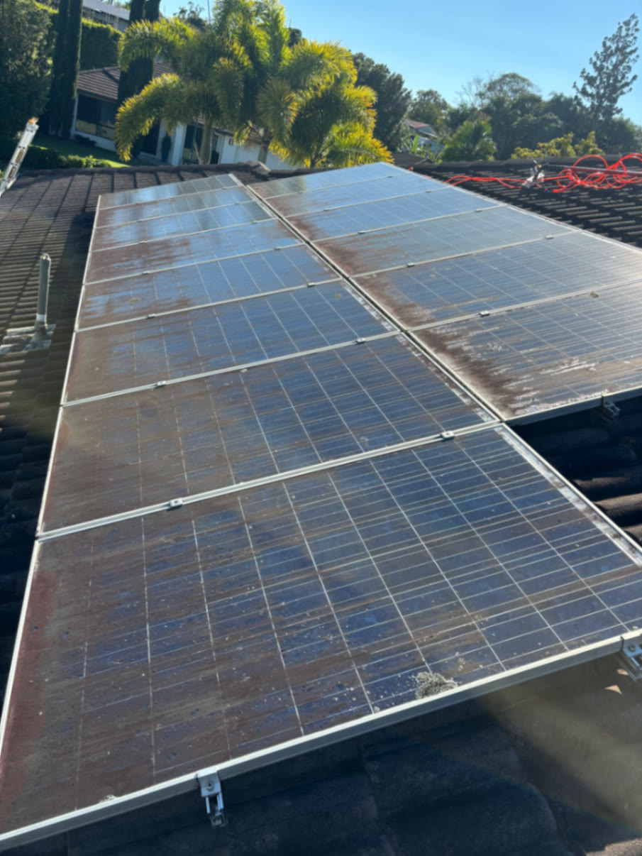 Solar panels caked in grime and salt before cleaning