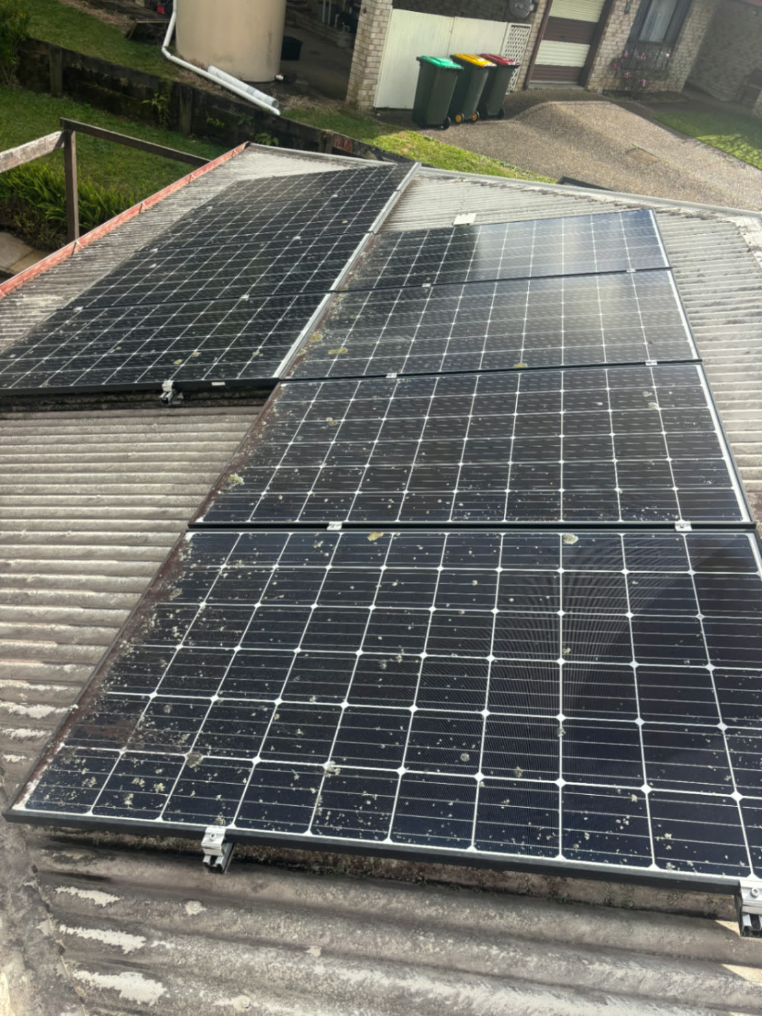 Solar panels covered in lichen and bird mess before a clean